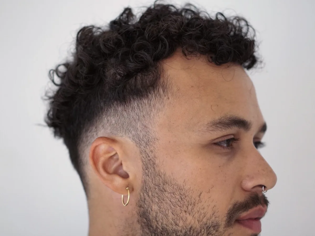 Curly crop with a skin fade, profile view